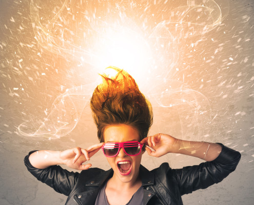 Young woman with energetic exploding red hair concept on background