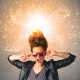 Young woman with energetic exploding red hair concept on background